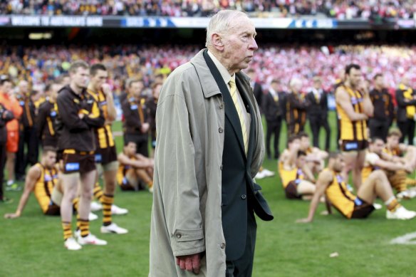 John Kennedy Sr stands with the Hawks after their 2012 grand final defeat. 