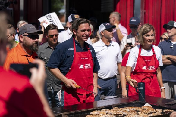 Ron DeSantis flips pork burgers at the Iowa Pork Producers tent at the Iowa State Fair.