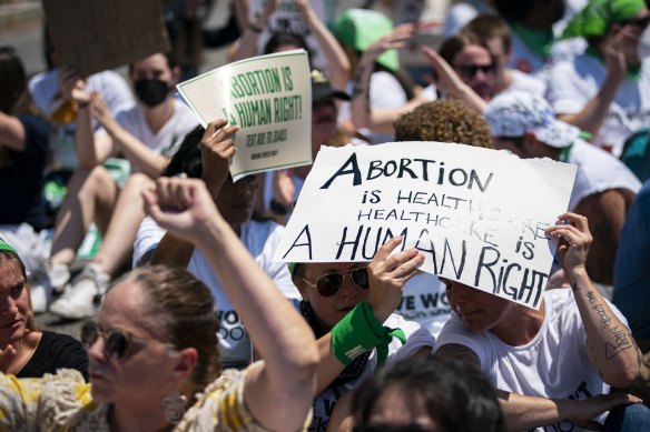 Abortion rights demonstrators block an intersection while sitting in the road during a protest near the US Supreme Court on Thursday.
