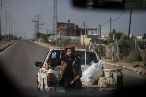 A Palestinian man rides on the back of a pickup truck in Rafah, Gaza, on Saturday.