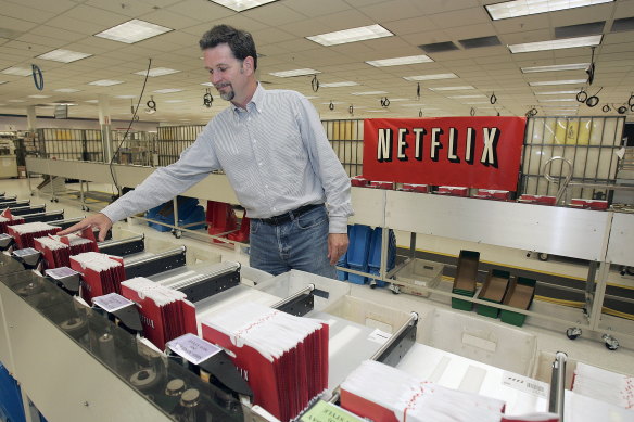 How it began: Netflix co-founder Reed Hastings looks through DVD envelopes in 2005.