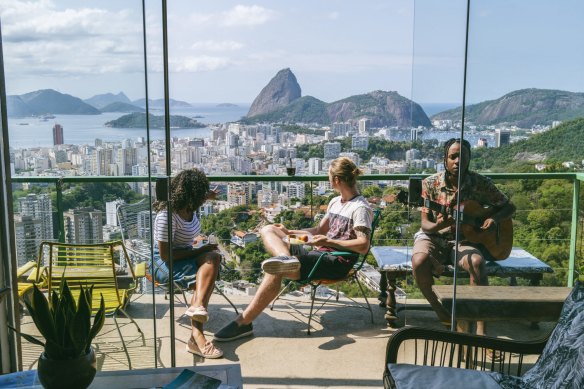Travellers at a hostel in Rio de Janeiro. Embracing hostels and backpacker accommodation, regardless of your age, is a great way to save.