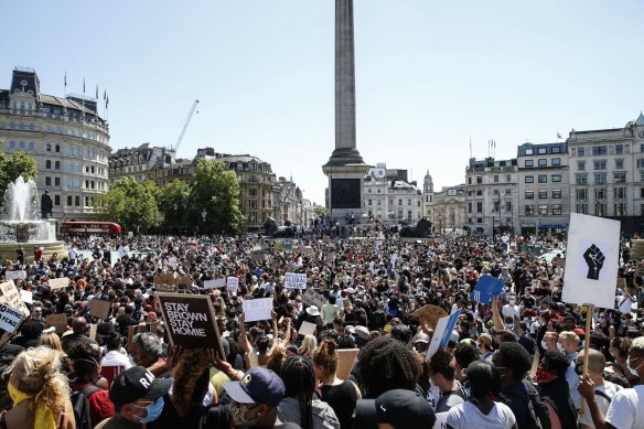 People hold placards as they join a spontaneous Black Lives Matter march at Trafalgar Square in London.