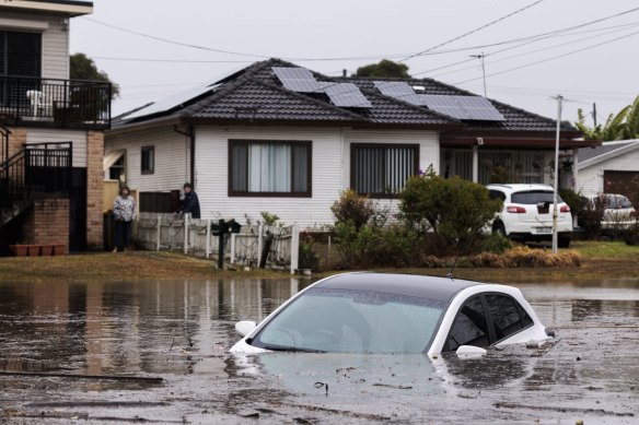 Heavy flooding in Lansvale as waters rise along the Georges River on Sunday.