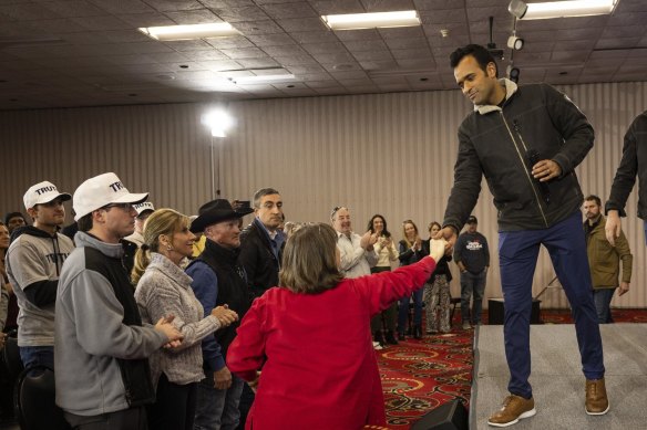 Vivek Ramaswamy shakes hands with a supporter at a campaign event in Des Moines, Iowa.