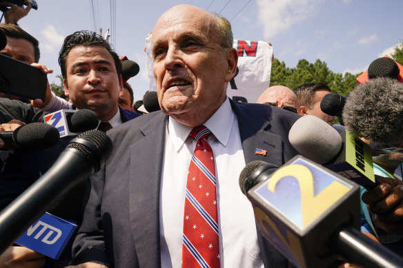 Rudy Giuliani speaks outside the Fulton County jail in Atlanta.