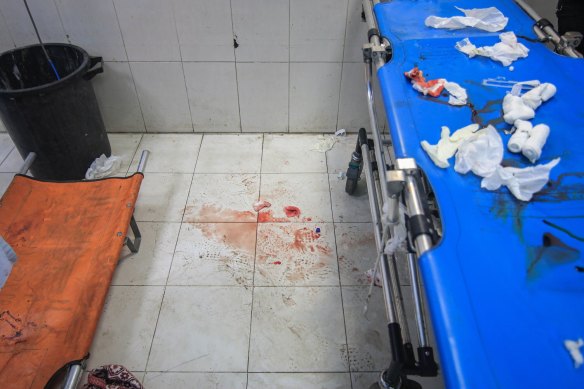 Blood stains on the floor and used bandages on a gurney after the treatment of injured Palestinians at the Nasser Medical hospital, in southern Gaza.