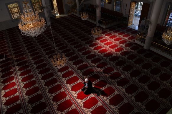 Auburn Gallipoli Mosque General Manager Ergun Genel prays alone due to the coronavirus.