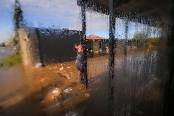 Rochester Motel owner Matthew Keating inspects the flood waters.