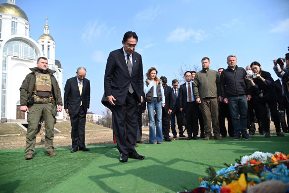 Japanese Prime Minister Fumio Kishida, centre, offers prayers, at a church in Bucha, a town outside Kyiv that became a symbol of Russian atrocities against civilians, in Ukraine.