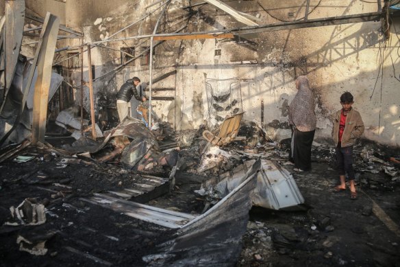 Palestinians inspect the damage following an Israeli strike on Monday in the courtyard of the Al Aqsa Martyrs Hospital in Deir al-Balah, central Gaza.