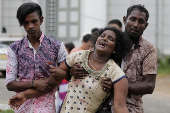 Relatives of a blast victim grieve outside a morgue in Colombo, Sri Lanka.