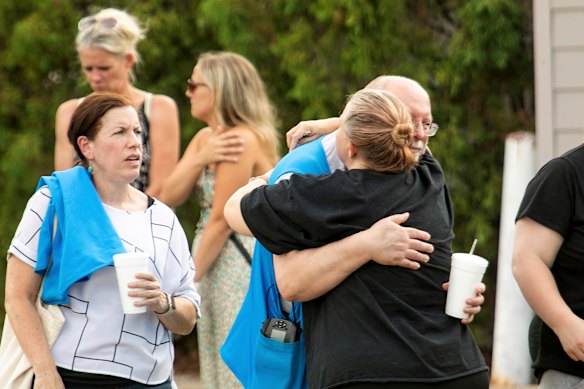 Walmart employees and customers comfort each other.