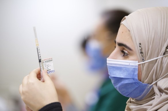 Tuka Tahir prepares a jab at the Melbourne Showgrounds vaccine hub on Wednesday.