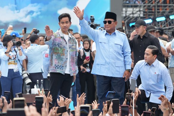 Prabowo Subianto (right-centre) greets supporters with Gibran Rakabuming Raka, his vice-presidential candidate and the son of President Joko Widodo.