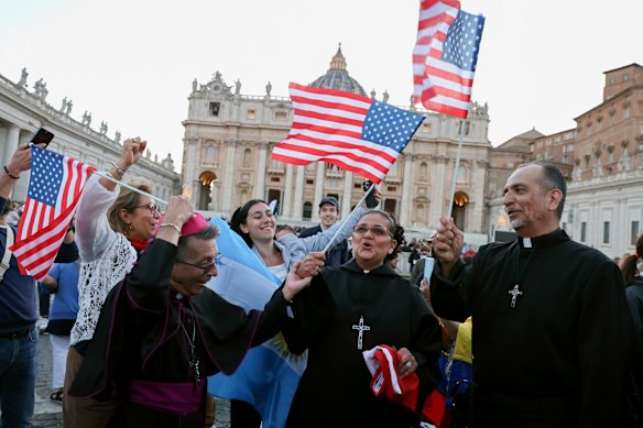 US flags wave in the air as Catholics celebrated Pope election.