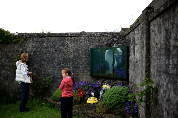 A mother and daughter visit the site where  796 children are believed to have been interred at St  Mary's Mother and Baby Home in Tuam, Ireland.
