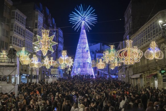 Crowds attend the lighting ceremony for Christmas decorations in Vigo, Spain. 