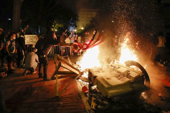 Demonstrators near the White House in Washington start a fire as they protest in the aftermath of the death of George Floyd. Floyd died after being restrained by Minneapolis police officers.