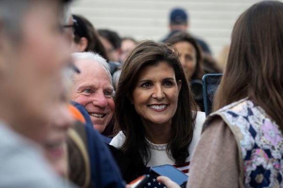 Nikki Haley takes photos with attendees during a bus tour campaign event at Moncks Corner Train Depot in Moncks Corner, South Carolina.