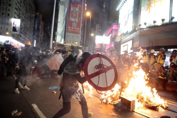 A protestor uses a shield to cover himself as he faces police in Hong Kong, Saturday, August 31, 2019. 