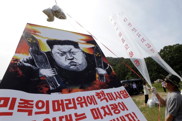 Defectors prepare to release balloons carrying leaflets and a banner denouncing Kim Jong-un in 2016. Campaigns like these enrage the Kim regime.