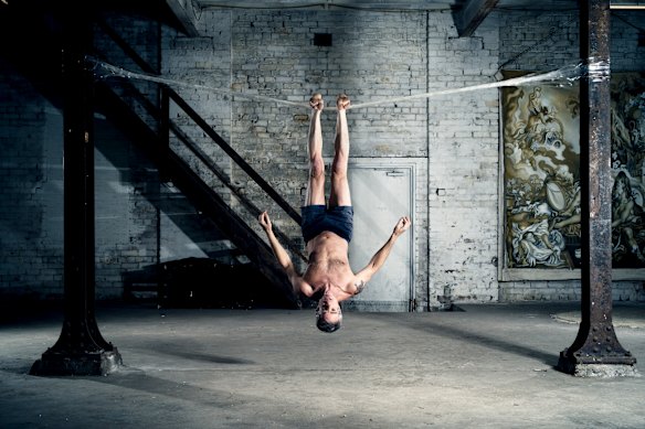 Lee Wilson dangles from a packing tape tight-rope.