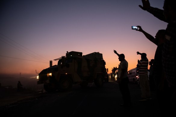 Turkish soldiers prepare to cross the border into Syria in Akcakale.