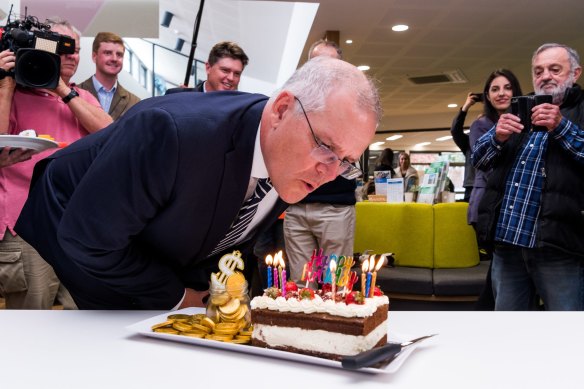 Prime Minister Scott Morrison blows out birthday candles on the campaign trail today.