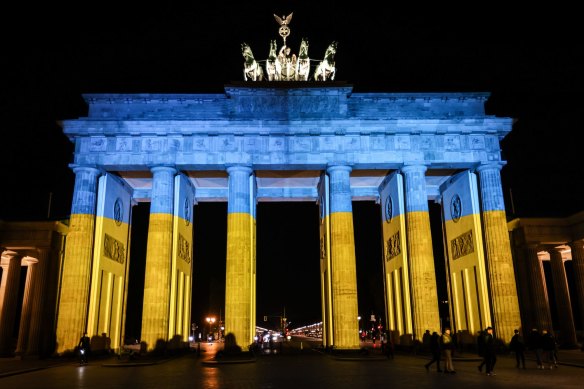 The Brandenburg Gate is lit in the blue and yellow colours of the Ukrainian national flag in solidarity with Ukraine and its people in Berlin, Germany.