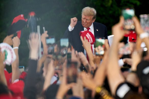 Former US president Donald Trump, centre, dances during a campaign event at Crotona Park in the Bronx on Friday (AEST).