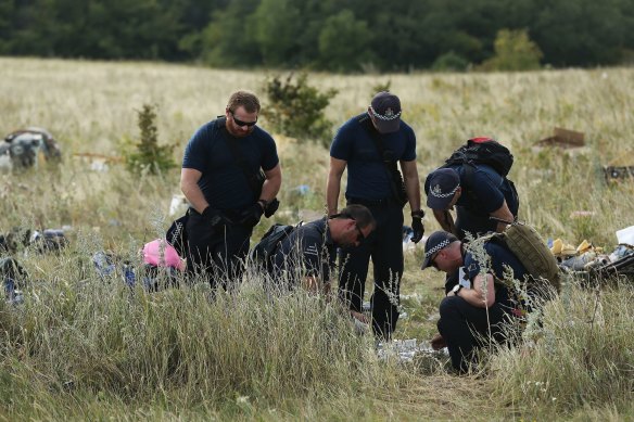 Australian Federal Police officers and their Dutch counterparts at the MH17 crash site in the fields outside the village of Grabovka in eastern Ukraine.