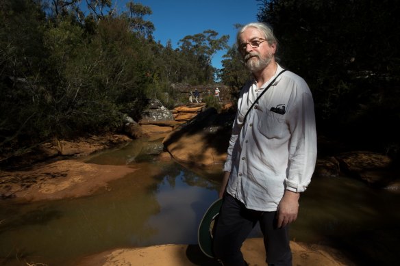 Peter Turner, from the National Parks Association of NSW, examines iron contamination of the Eastern Tributary, in the Woronora catchment area, south of Sydney. 