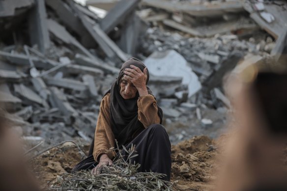 A Palestinian woman among rubble after Israeli shelling in the Nuseirat refugee camp in central Gaza.