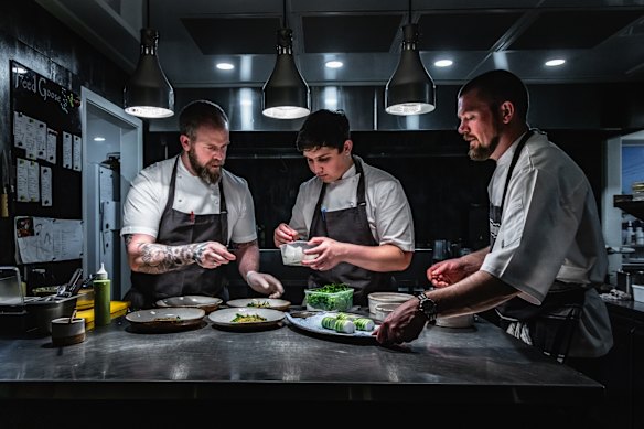 A trio of chefs prepare dishes inside the kitchen of Taupo’s 30-seat Embra restaurant.