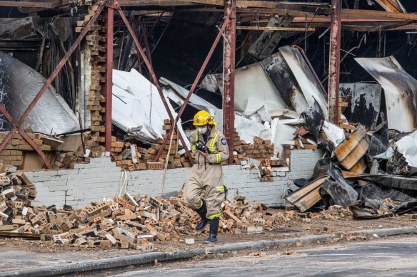 Fire crews at Little Saigon Market the day after it burnt down in December 2016.