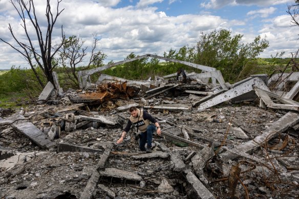 Journalists visit the site of a destroyed Russian munitions depot on to the east of Kharkiv on Monday.