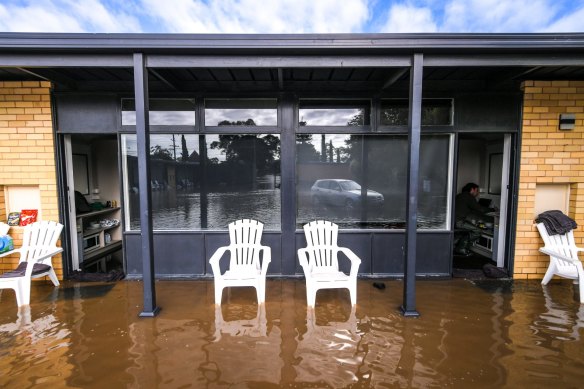 Age reporter Benjamin Preiss working in his flooded motel room in Rochester.