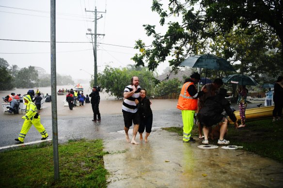 People make their way to safety in Lismore on February 28.