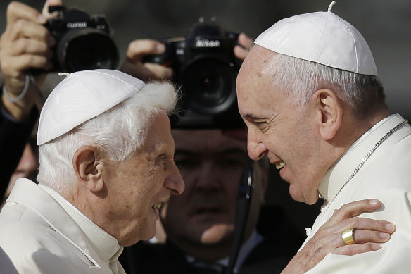 Pope Francis (right) and Pope Emeritus Benedict XVI embrace in 2014.