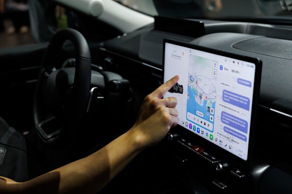 A passenger touches a screen inside a Hyundai Avante sedan at a car show in Busan, South Korea, in June.