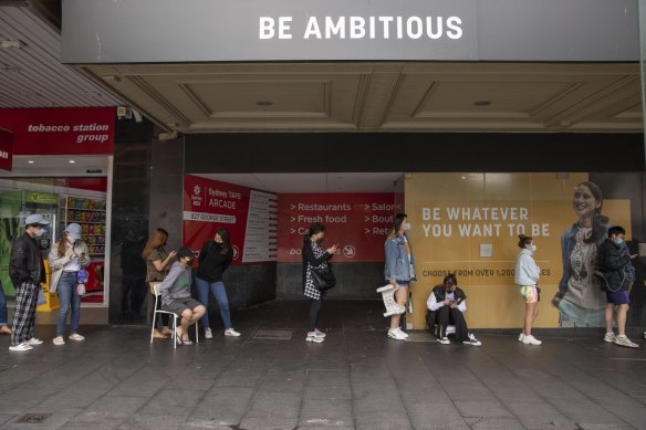 People lining up for a COVID-19 PCR test in Sydney CBD brought their own chairs on Tuesday.