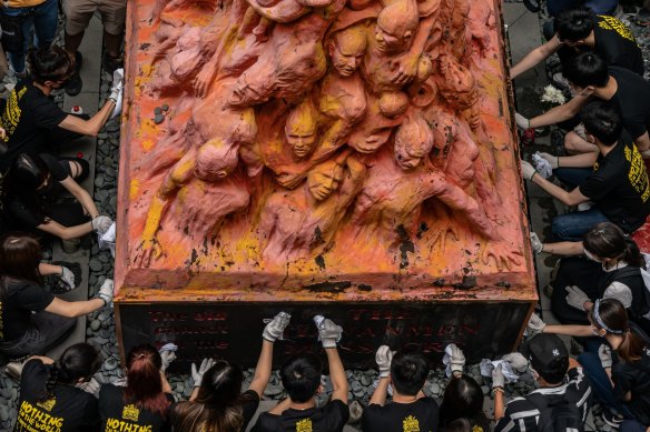 Students clean the Pillar of Shame on June 4, this year, to commemorate the anniversary of the 1989 Tiananmen Square massacre.