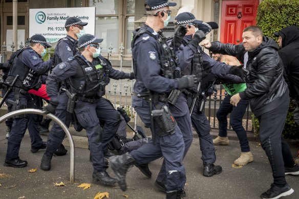 Victoria Police confront protesters in Victoria Street, North Melbourne, on May 29 for breaching lockdown directives. 