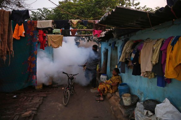 An Indian health worker fumigates to prevent the spread of mosquito-borne diseases in Allahabad, India.