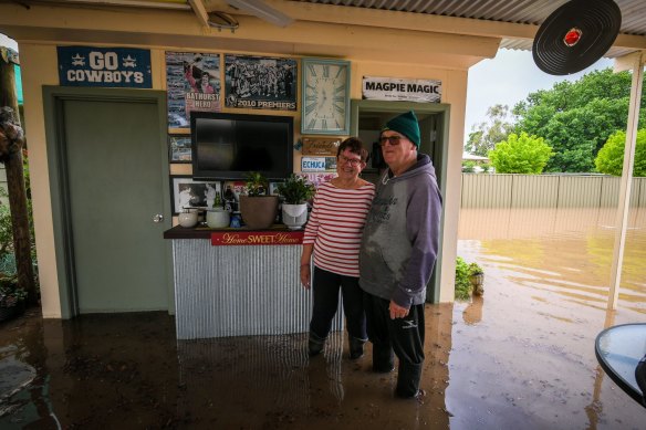 Brian and Glenys Mulcahy smile in the face of the floodwaters threatening their home of 54 years.
