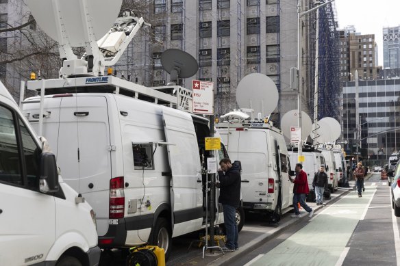 Television news vehicles outside the district attorney’s office.