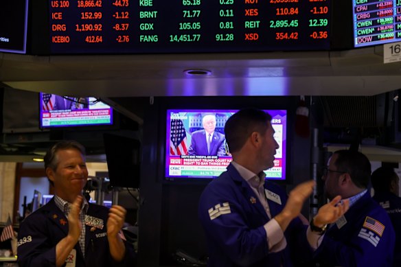 Traders on the floor of the New York Stock Exchange react as news of the Supreme Court’s decision is broadcast.