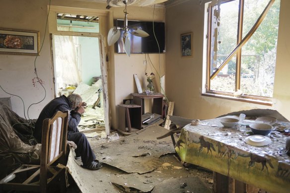 Yury Melkonyan, 64, sits in his house damaged by shelling from Azerbaijan's artillery during a military conflict in the separatist region of Nagorno-Karabakh.