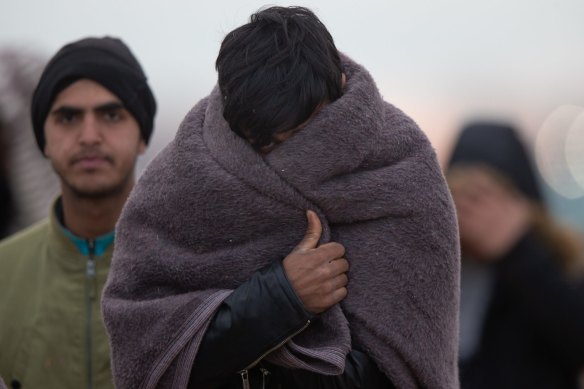 Refugees and migrants walk with their belongings to Turkey's Pazarkule border crossing on Saturday.